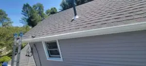 a roof of a house with new seamless gutter and guards
