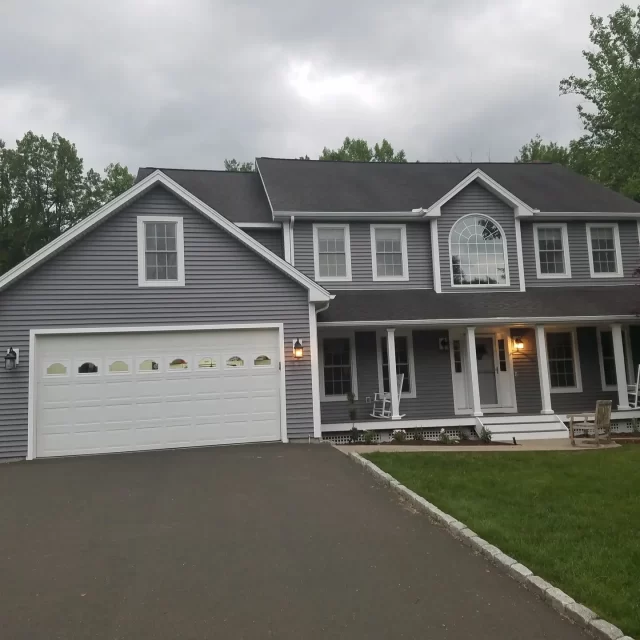a house with a driveway and a lawn