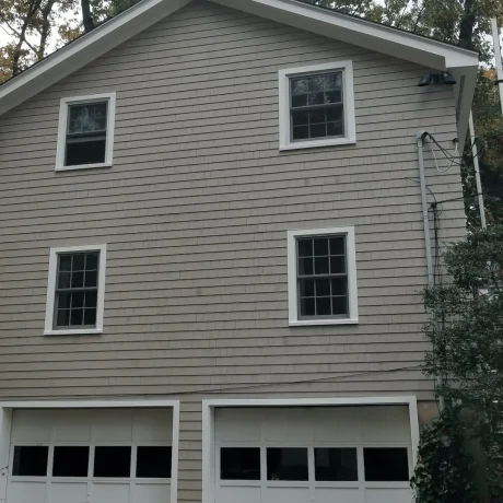 a house with new shake siding and a garage
