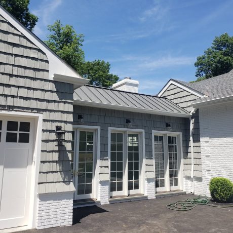 a house with metal roof and a door