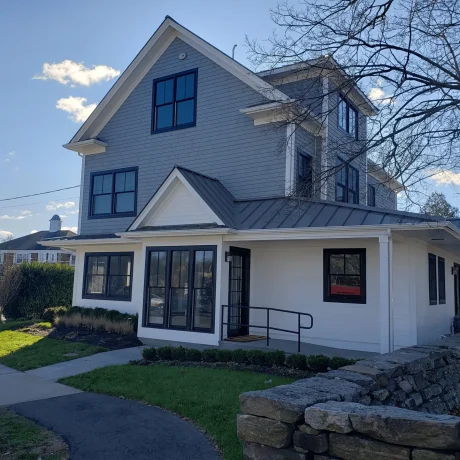 a house with a stone wall and a stone fence